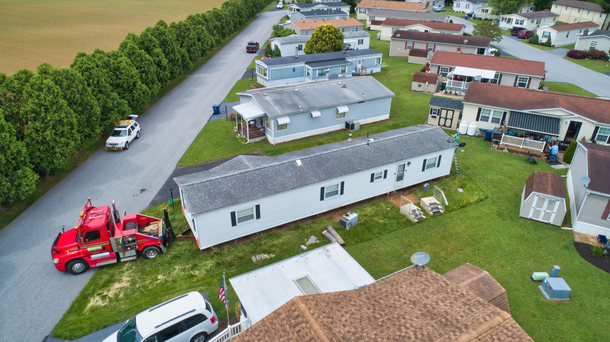 Manufactured Home Park – Aerial Community View for Insurance Coverage Aerial view of a manufactured home park with homes, utility systems, and a service truck, representing manufactured home and RV park insurance coverage.”